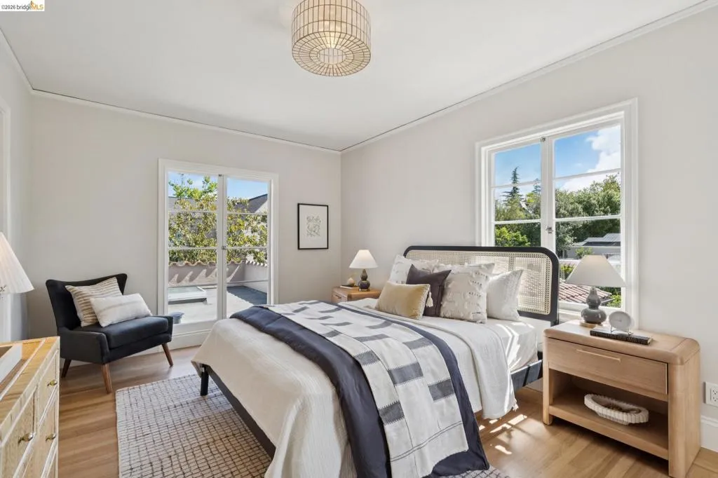 Bedroom featuring wood-finish flooring, a contemporary ceiling light fixture, and crown molding