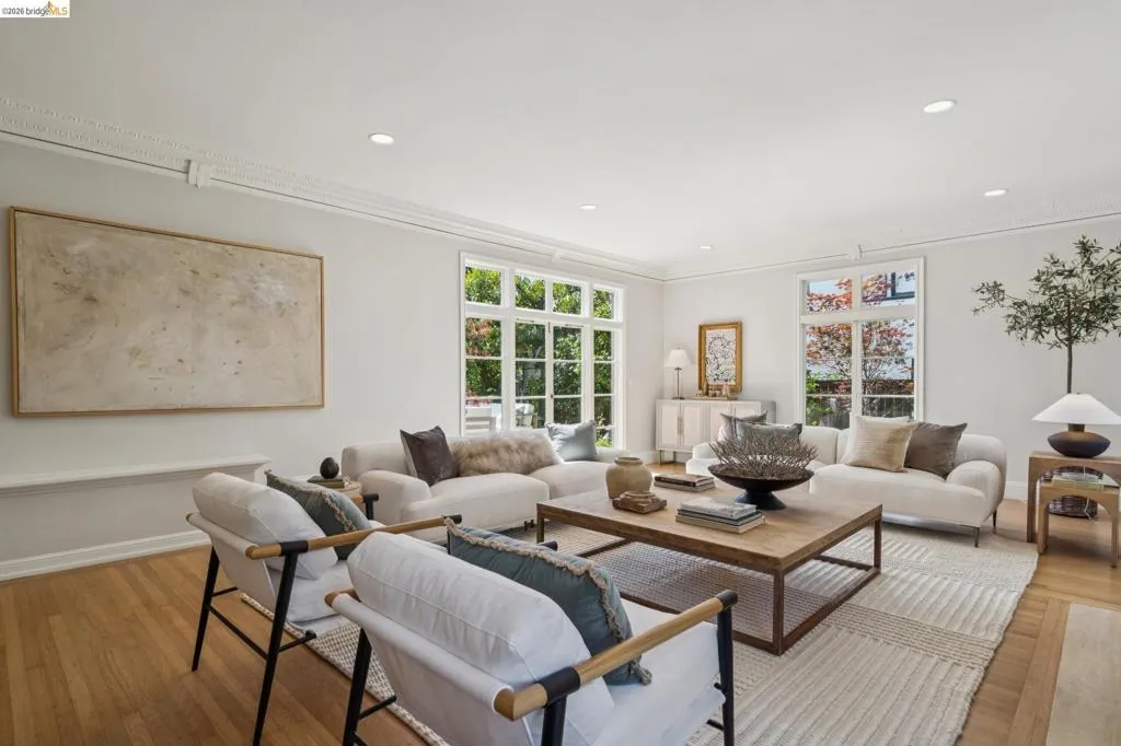 Spacious living area featuring wood-finish flooring, recessed lighting, and crown molding