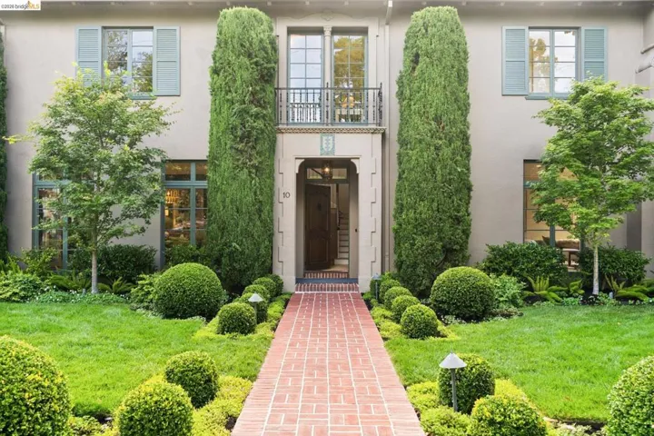 Stucco exterior residence with a brick-patterned pathway