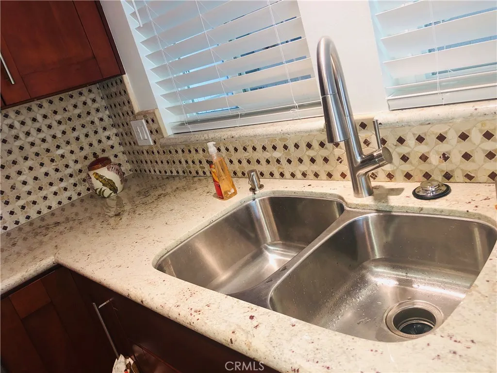 Dual sink with newer fixtures, complimented by additional lighting and new blinds.