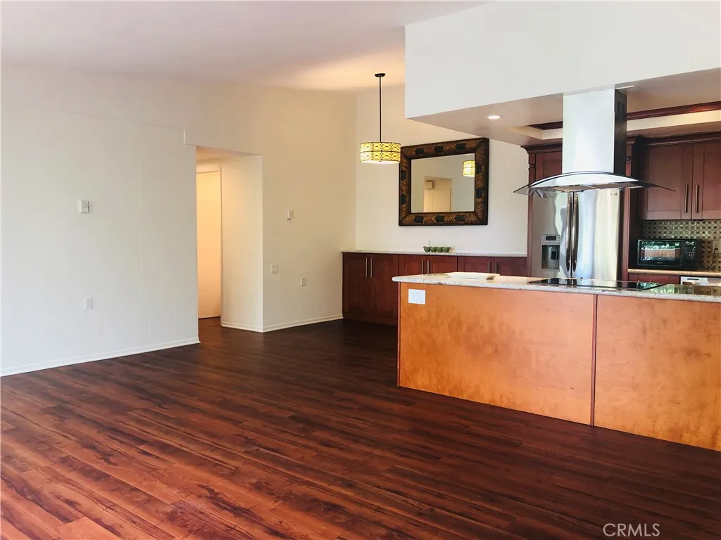 Cathedral ceiling, crown molding Dining room with matching built-in buffet, granite counters, and designer mirror.