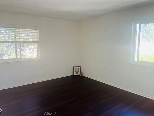 Master Bedroom Suite includes new wood-like flooring, and natural light flooding through 2 windows, tree views