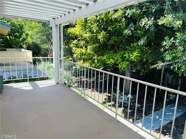 Large balcony capped by a designer patio cover offers outdoor living (photos from prior listing; fence lLiving room, with upgraded wood-like flooring, has access to a large balcony open to the tree tops and numerous walking trails