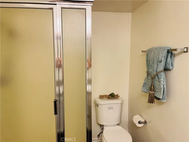 Hall bathroom has walk-in shower and new toilet