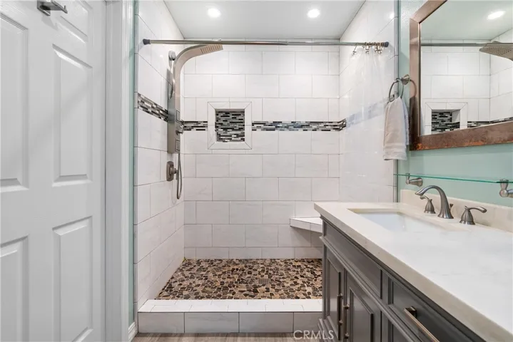 The ensuite bathroom boasts a fantastic walk-in shower with a clever niche and powerful shower system.