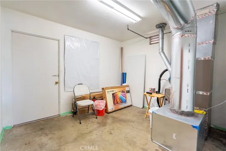 Next to the office you will find a utility room. It can be used for additional storage or a workshop area.