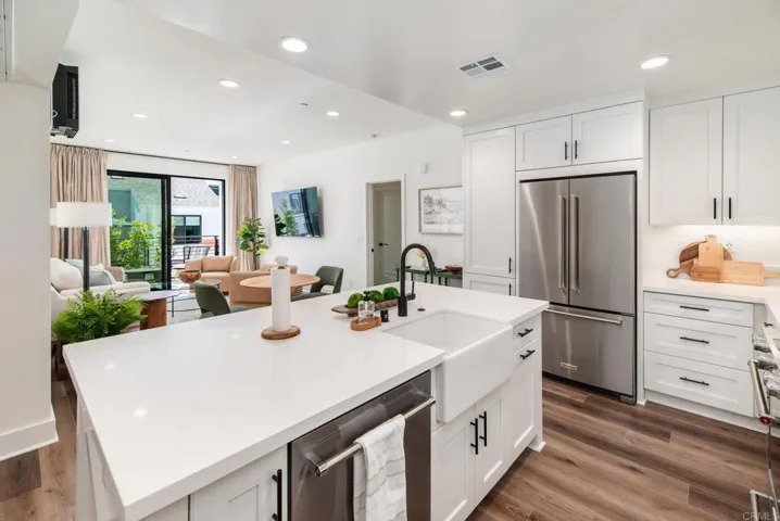 Chefs kitchen with KitchenAid gas range, microwave, dishwasher and french door refrigerator.