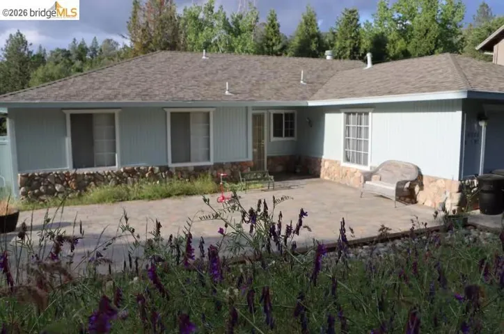 Light blue siding exterior featuring a stone accent foundation