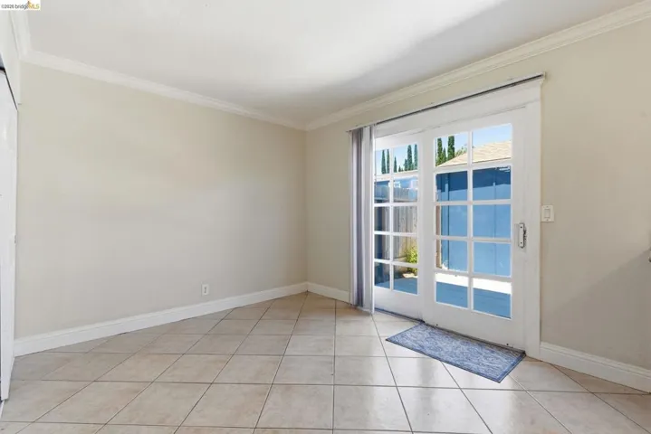 Neutral-toned walls paired with a tile floor and white baseboards