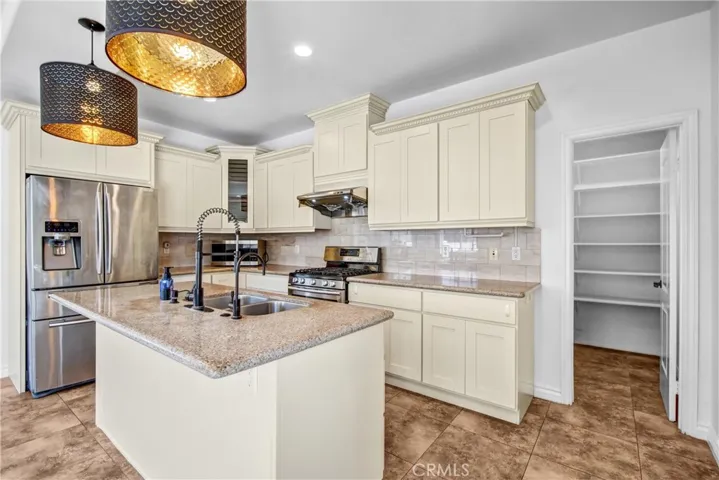 Updated kitchen with center island and walk-in pantry.