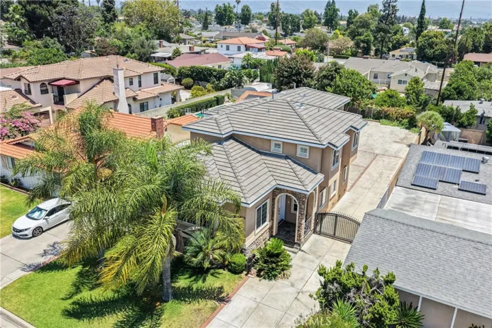 Aerial view showcasing the property's expansive frontage and long driveway