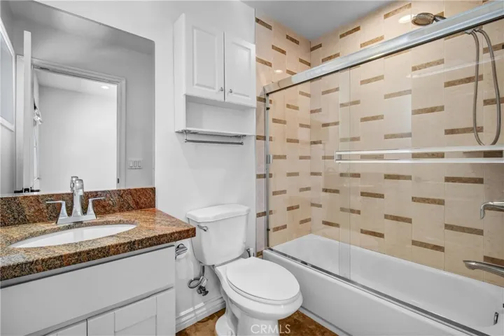 Downstairs updated full bathroom with tiled walk-in shower.
