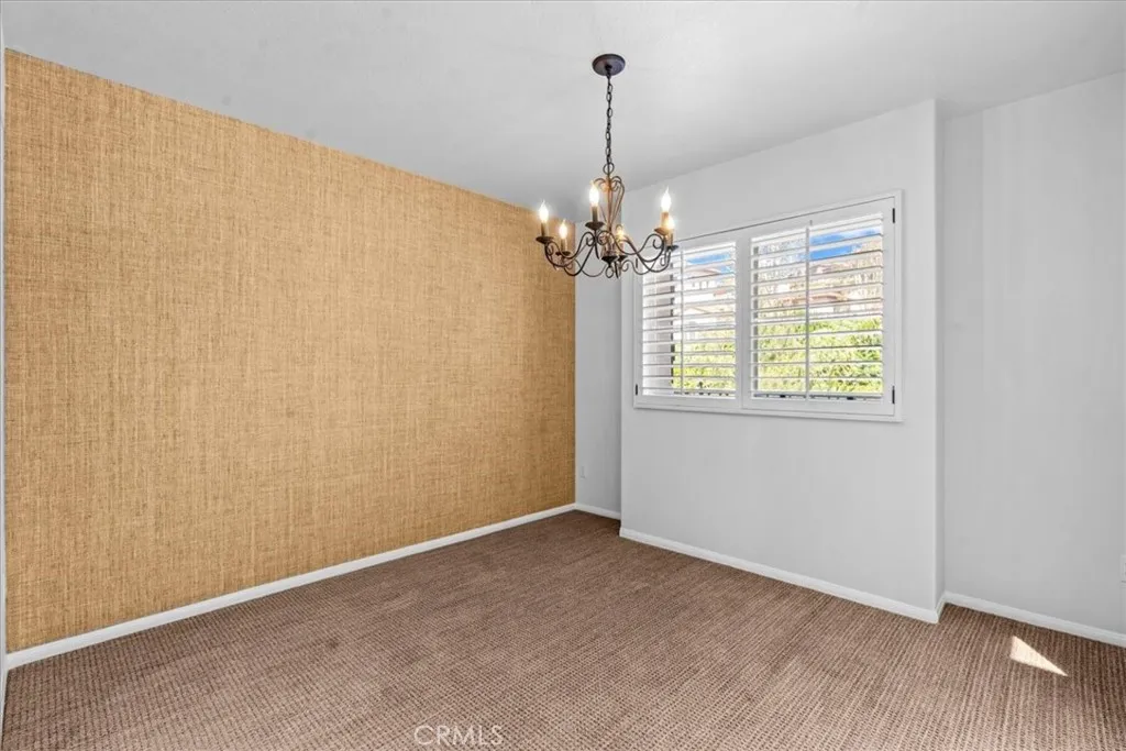 Dining area with designer grass cloth wallpaper