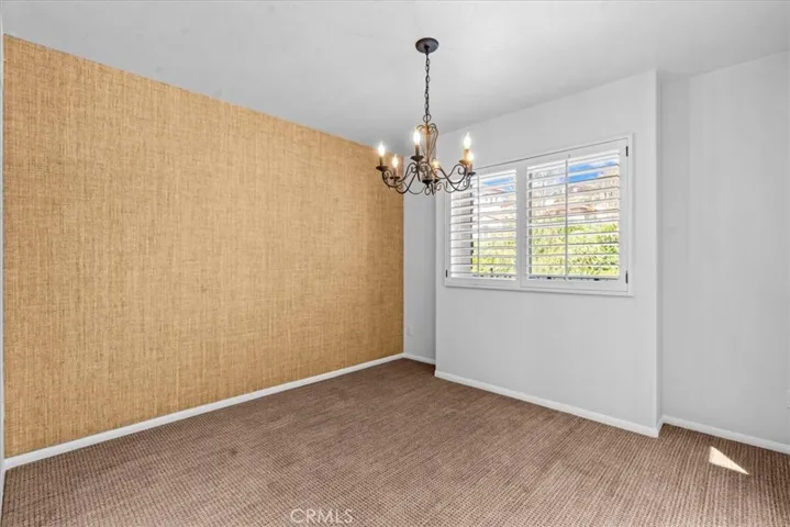 Dining area with designer grass cloth wallpaper
