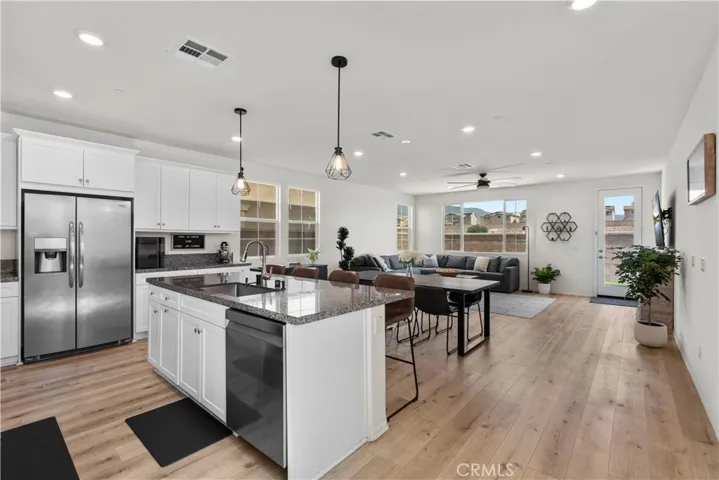 Open concept great room with kitchen, dining, living room