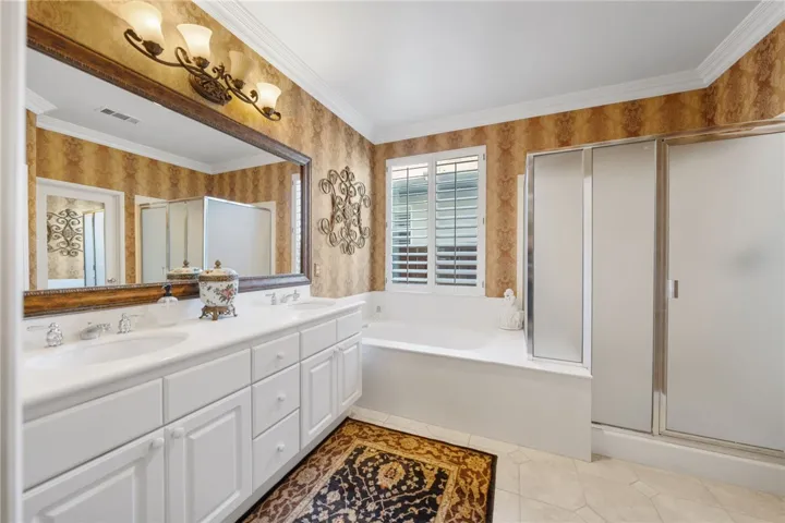 Primary bath with dual sinks, soaker tub and separate shower with privacy glass