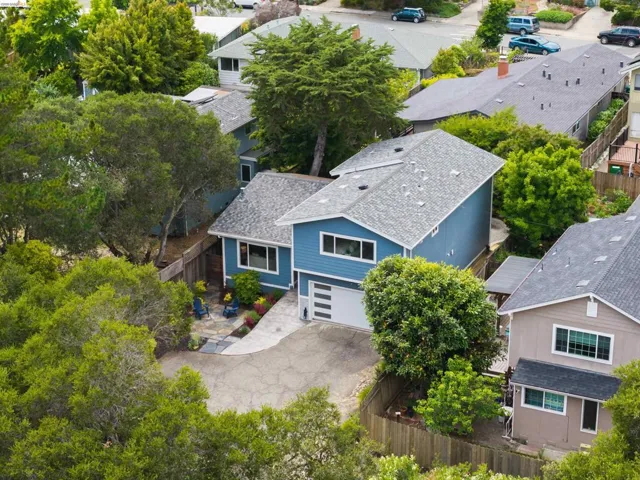 Contemporary blue siding residence with a light gray shingle roof