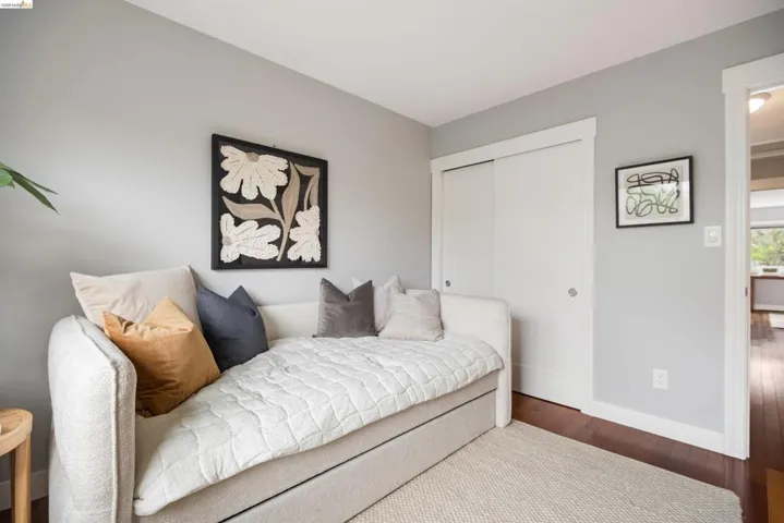 Interior room with light gray walls, white trim, and dark wood-finish flooring