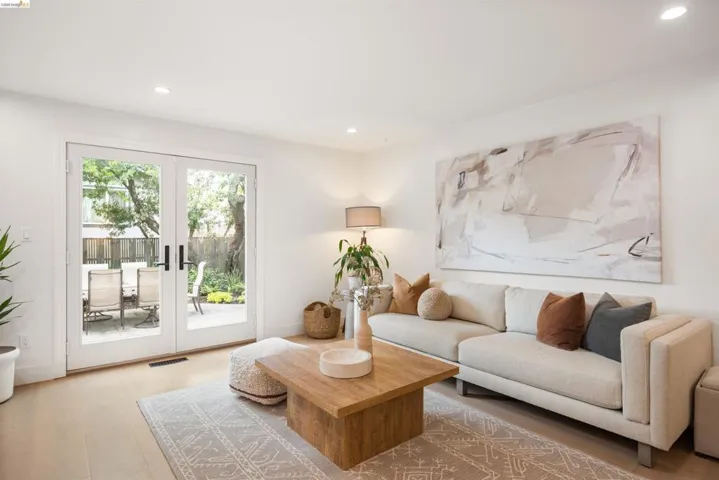 Living area featuring wood-finish flooring, recessed lighting, and white walls