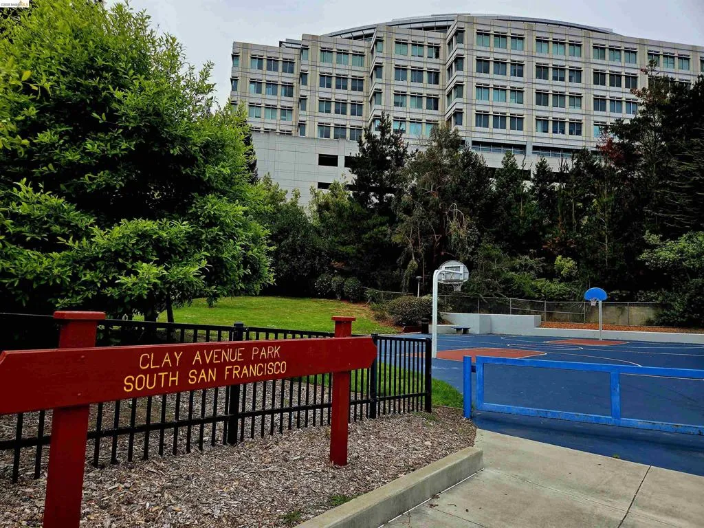 Clay Avenue Park sign with black metal fencing