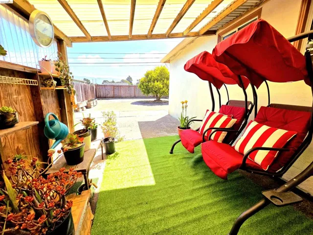 Covered patio featuring a translucent panel roof and wood beam supports