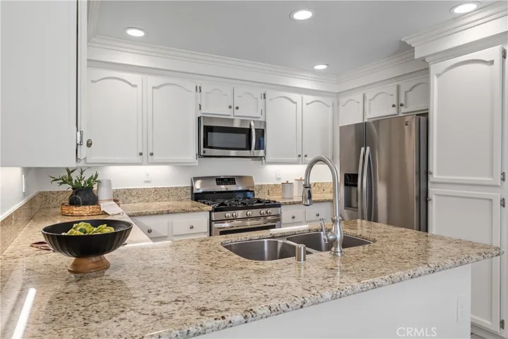 Freshly painted cabinetry with granite countertops.