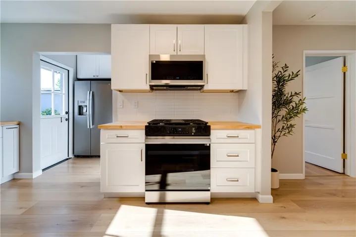 Washer and dryer is next to the refrigerator.