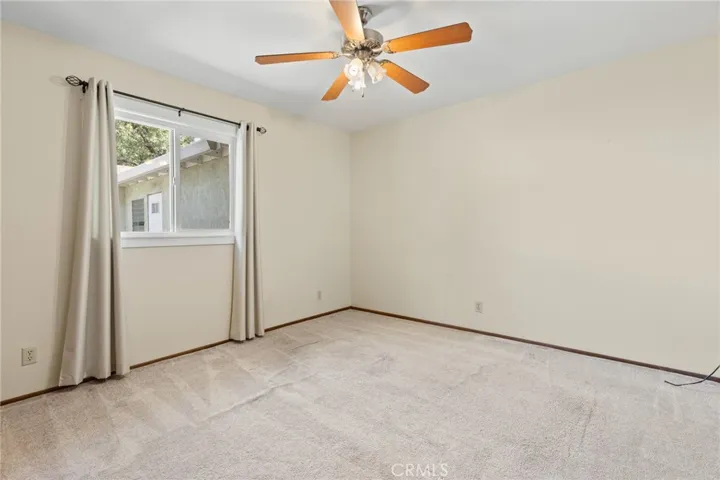 Duplex - 1700 Sherman  - Bedroom 2 with ceiling fan, carpet and upgraded window.