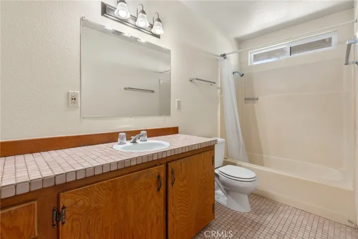 Duplex - 1700 Sherman  - Bathroom with tile counter top and floors and upgraded window.