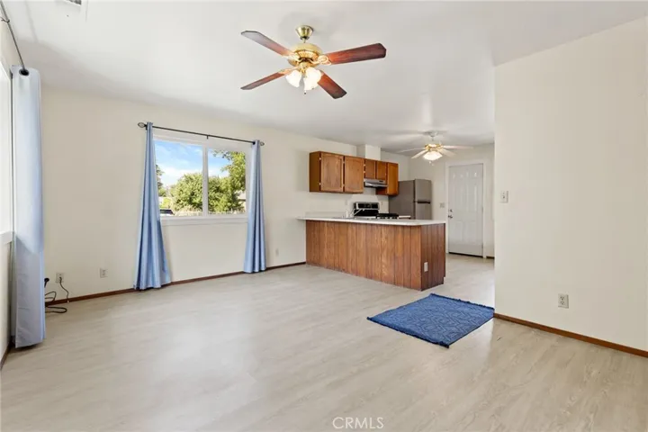 Duplex - 1700 Sherman - Kitchen and living room area, laminate floors, gas stove and refrigerator.