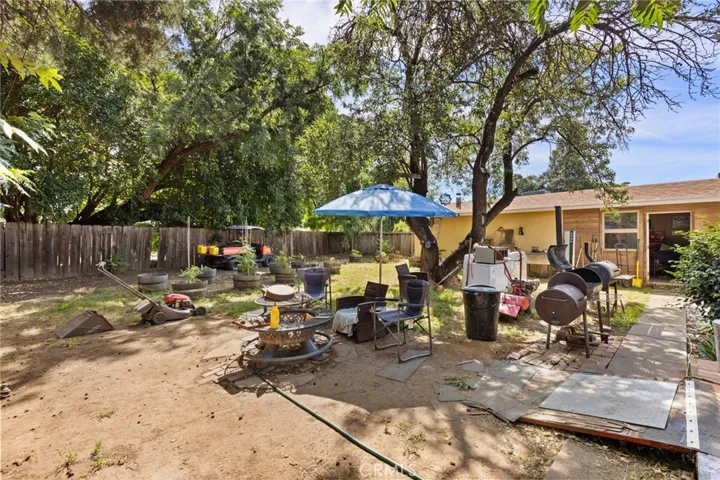 House - Spacious backyard with side view of garage.