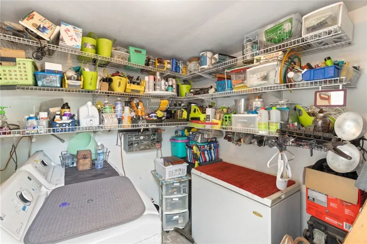 Duplex - 1701 Sheridan - View of laundry room with hook-ups, washer, dryer and freezer belong to tenants.