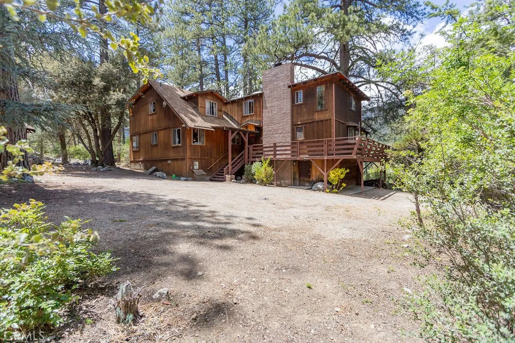 The rear of this main building offers golf course, lake and mountain views through the trees.
