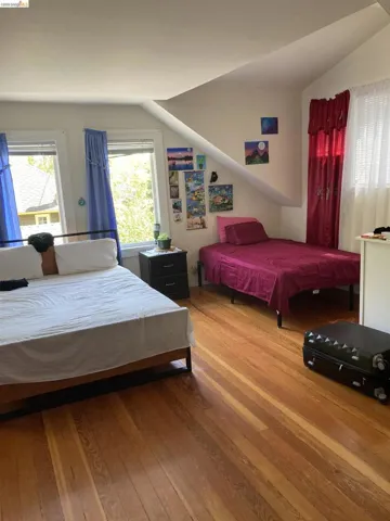 Bright room featuring wood-finish flooring and multiple windows