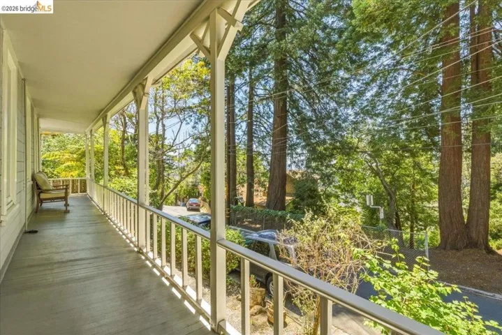 Covered porch with white railings and decorative posts