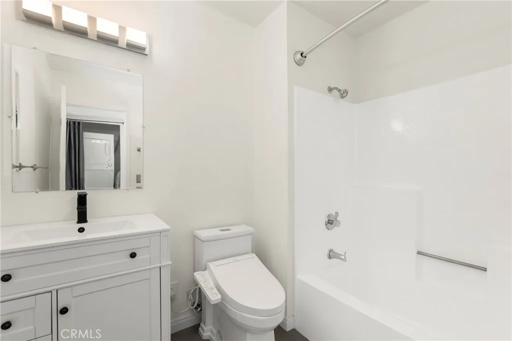 Remodeled bathroom has low flow toilet, modern fixtures, and full size tub.