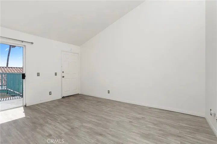 View of the living room, entry, and partial balcony. So light and airy.
