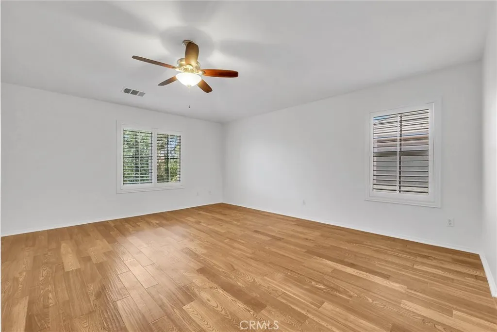 Primary bedroom has Tiger grained oak engineered hardwood flooring in excellent condition!