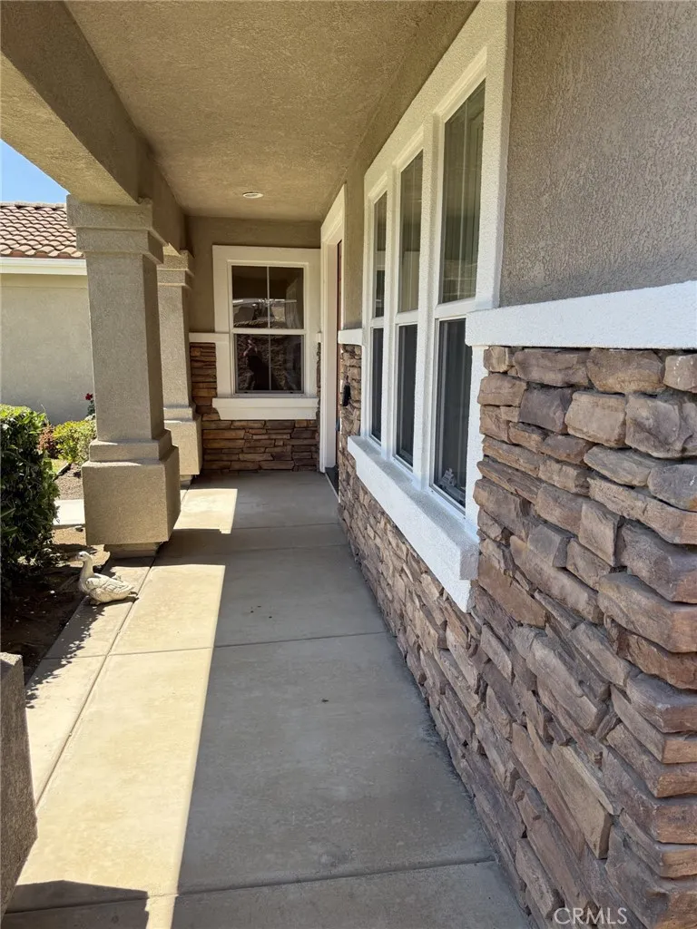 Porch is covered and has stone trim!