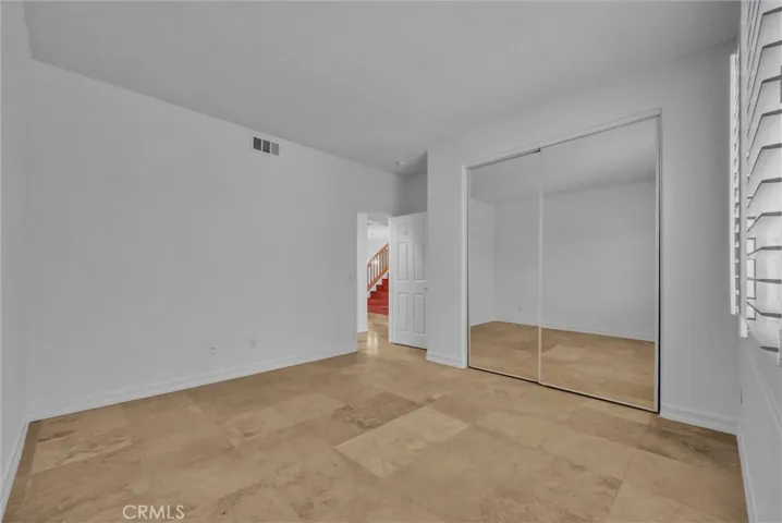 Downstairs bedroom with travertine floor.