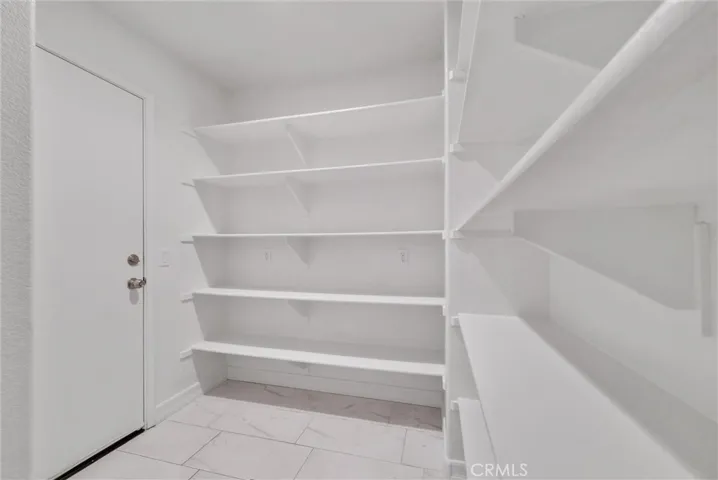 Walk-in pantry with direct garage access.