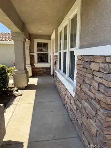 Porch is covered and has stone trim!