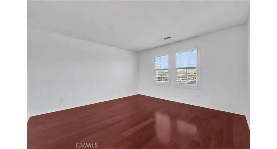 Bedroom windows have city light views.