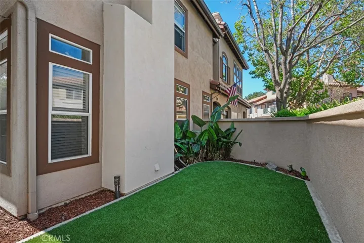 Side yard access with low-maintenance grounds and additional outdoor space, ideal for everyday enjoyment and convenience.