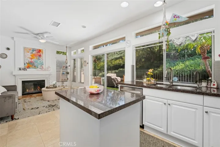 Another view of the kitchen highlighting the large windows and natural light that enhance the heart of the home.