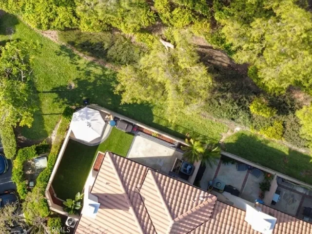 Bird's-eye view showcasing the property's setting surrounded by greenery, and tucked away in the back of this great community.