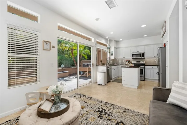 Open-concept living and kitchen area with expansive windows, offering a bright and airy atmosphere throughout the home.