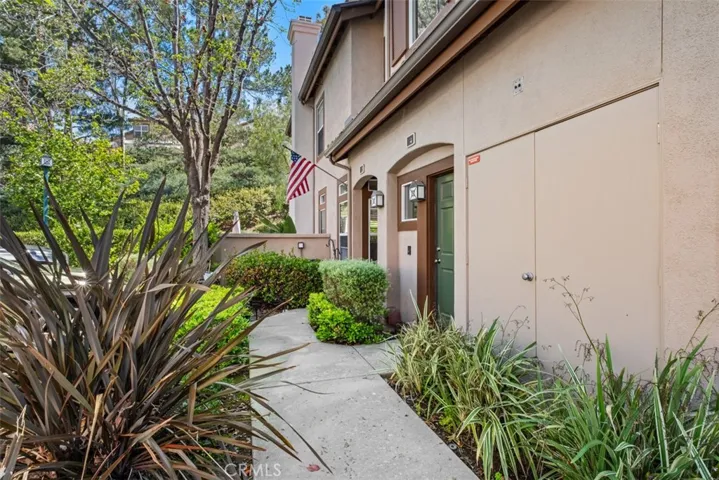 Tucked away in the most ideal secluded area, this charming front entry walkway bordered by mature landscaping, creats a warm and welcoming first impression as you approach the home.