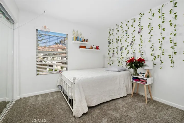 Bright secondary bedroom with ample natural light and versatile space to accommodate guests, family members, or a home office.