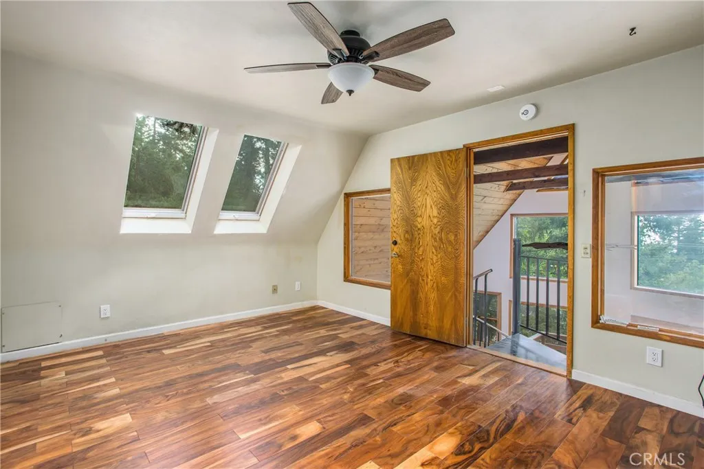 primary bedroom with balcony windows & sky lights with stunning views